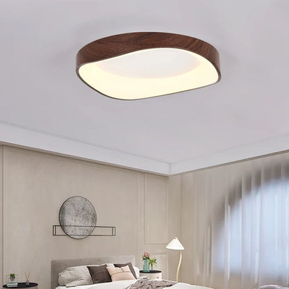 Dark wood-effect LED flush mount ceiling light in a bedroom