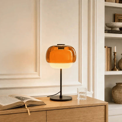 Orange retro glass lamp on a wooden cabinet