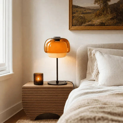 Orange double-dome lamp on a bedside table