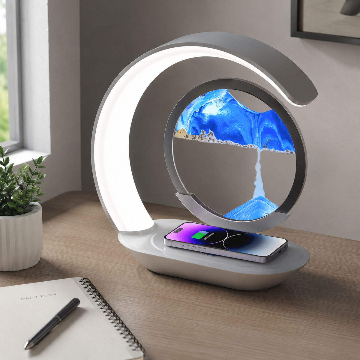Sandscape lamp charging a phone on a desk
