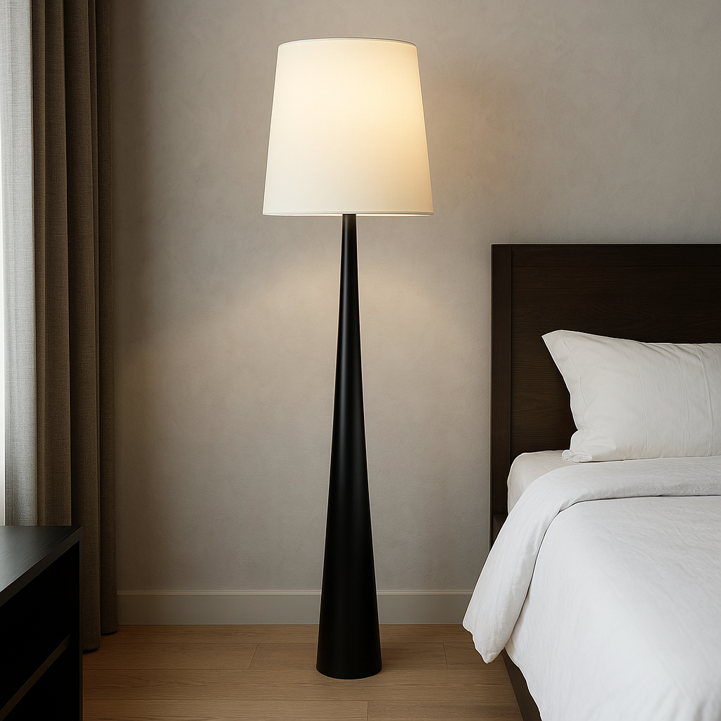 White shade floor lamp beside a bed
