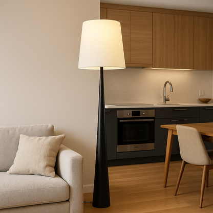Black floor lamp with fabric shade beside a sofa