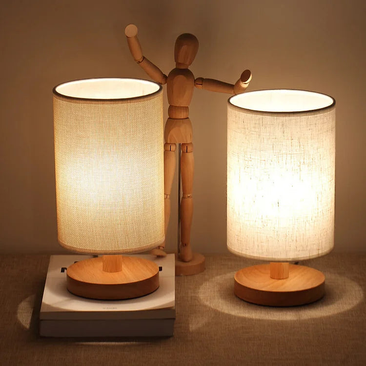 Two wood table lamps with cylindrical linen shades