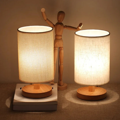 Two wood table lamps with cylindrical linen shades