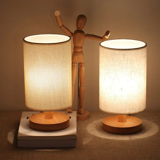 Two wood table lamps with cylindrical linen shades