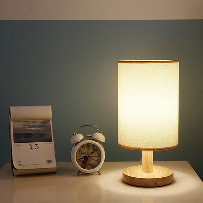 Linen-shade table lamp on a bedside cabinet