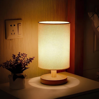 Linen-shade table lamp on a bedside table