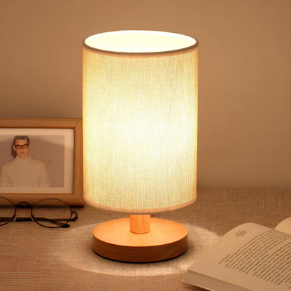 Scandinavian wood table lamp beside a book
