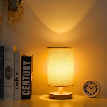 Scandinavian linen-shade table lamp beside a clock