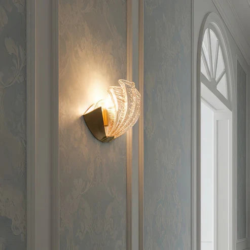 Side view of illuminated glass shell wall lamp