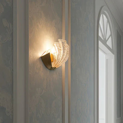 Side view of illuminated glass shell wall lamp