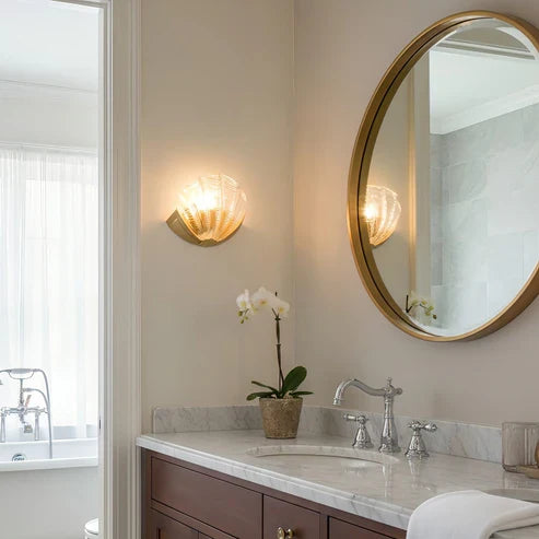 Seashell sconces beside a bathroom mirror