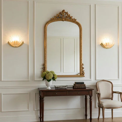 Glass shell sconces above a hallway table