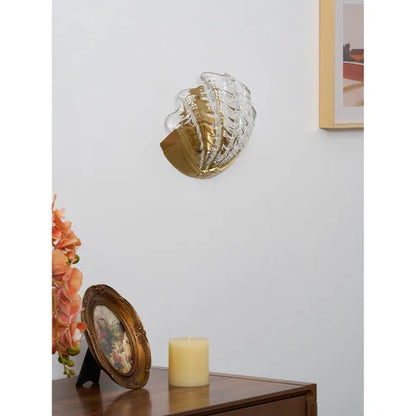 Clear glass seashell sconce switched off