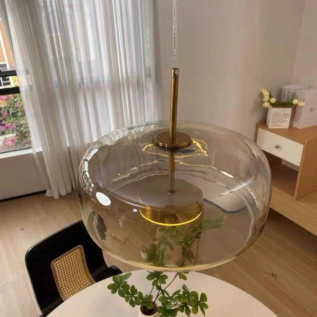 35 cm smoked grey glass dome pendant light above a round table, close-up