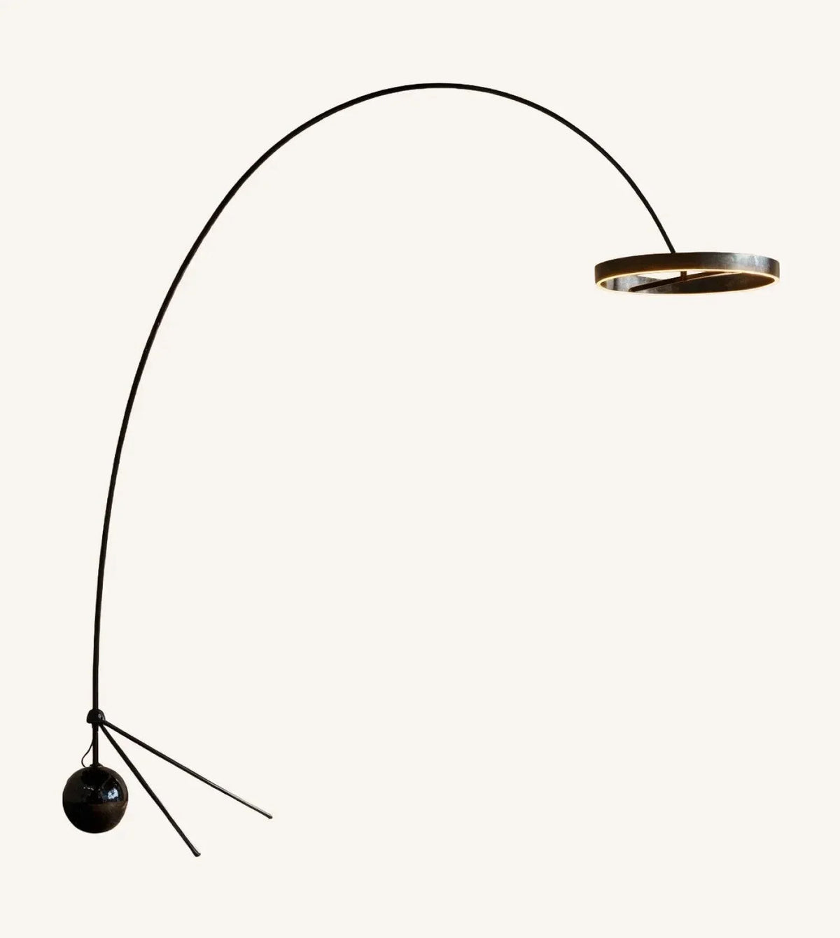 Black chrome arc floor lamp on a plain background