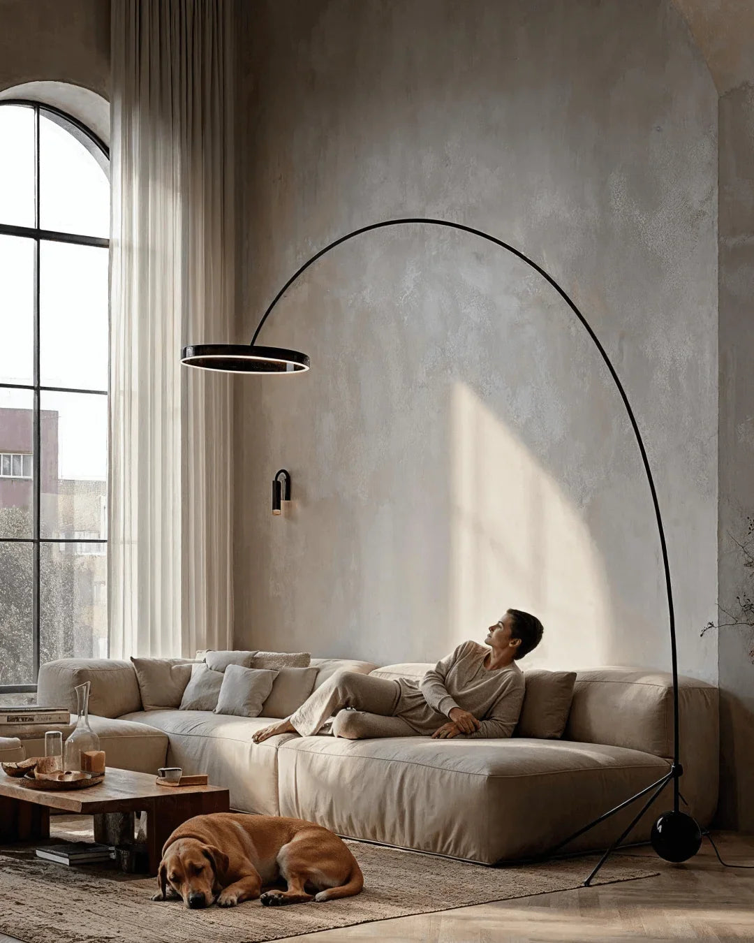 Large arc floor lamp above a seating area