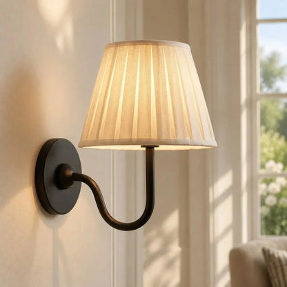 Bronze single-arm wall light with a pleated shade