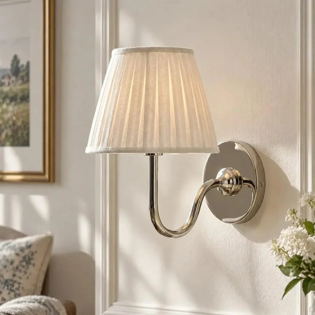 Chrome single-arm wall light with a pleated shade