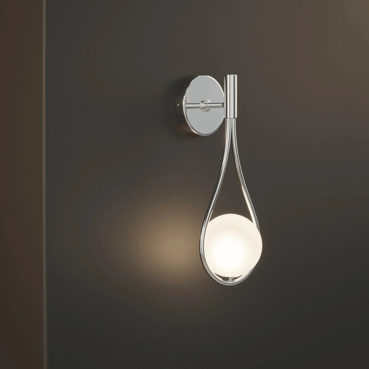 Silver teardrop wall sconce with soft glow