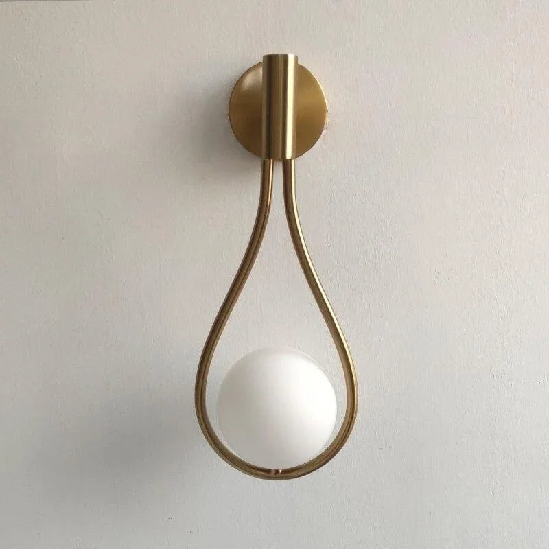 Gold teardrop wall light with white globe