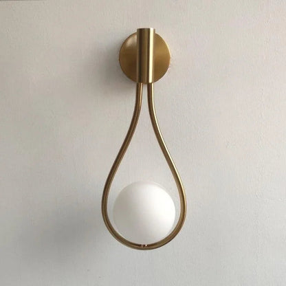 Gold teardrop wall light with white globe