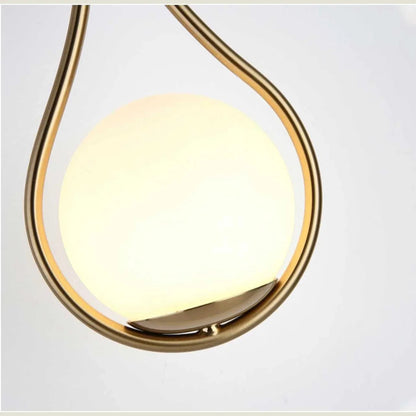 Close-up of opal globe in gold teardrop frame