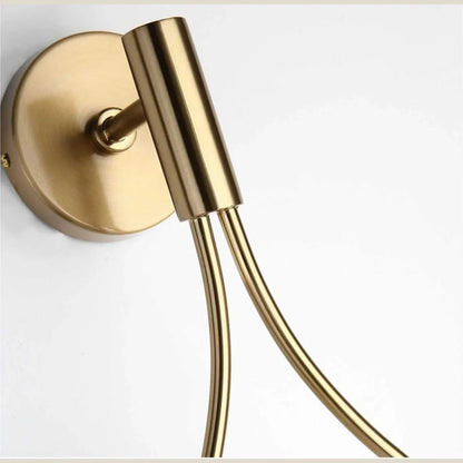 Close-up of gold wall plate and curved frame