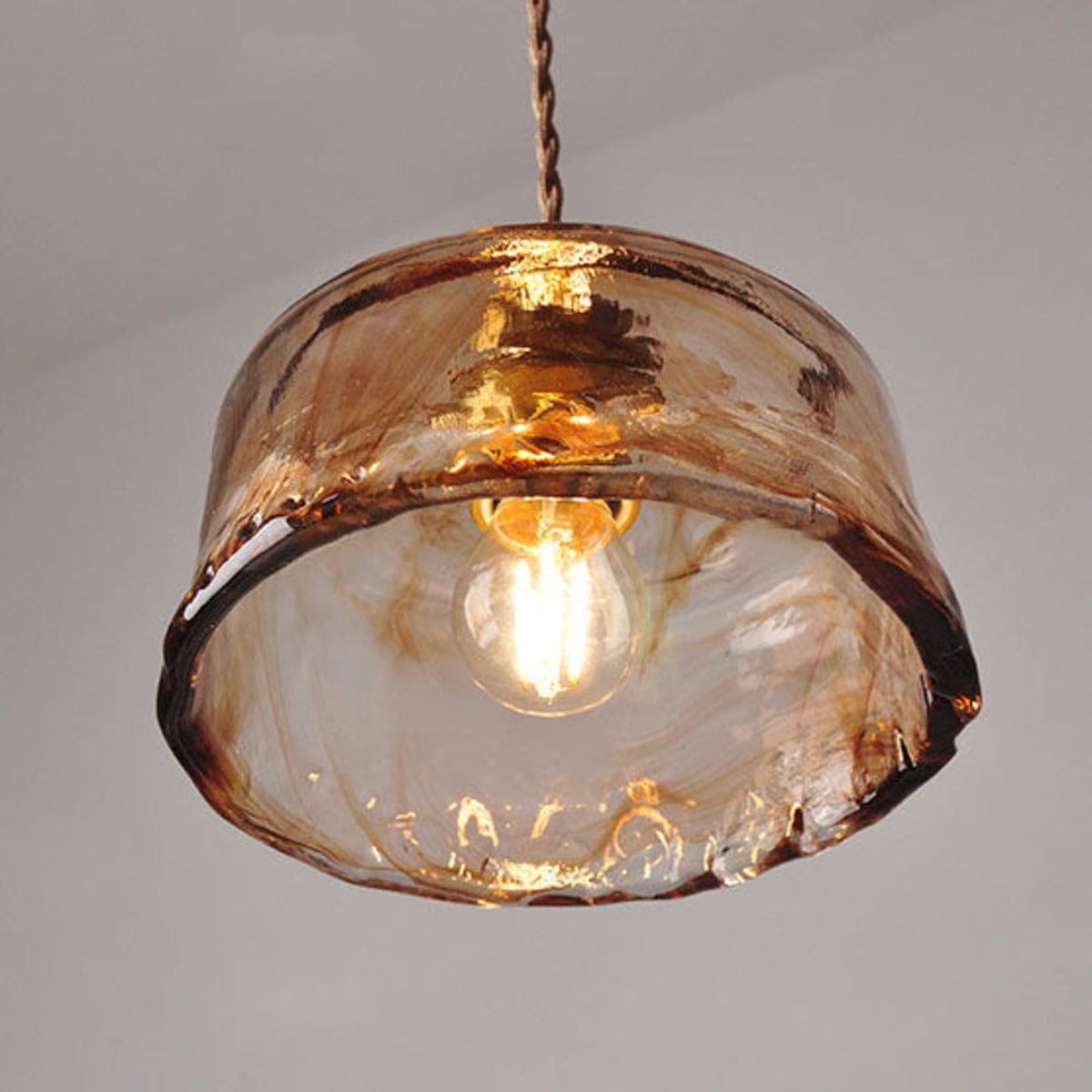 Underside of textured glass pendant shade and bulb