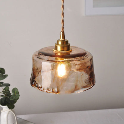Close view of textured glass shade and warm bulb