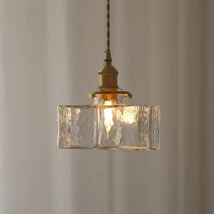 Rectangular glass pendant casting warm light