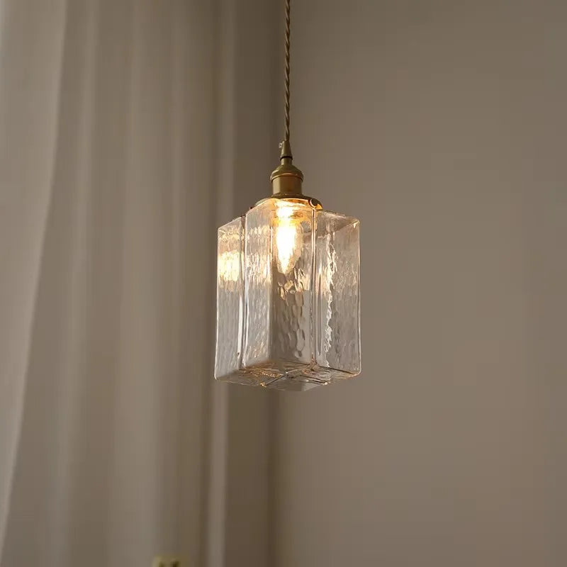 Tall textured glass pendant with a twisted cord