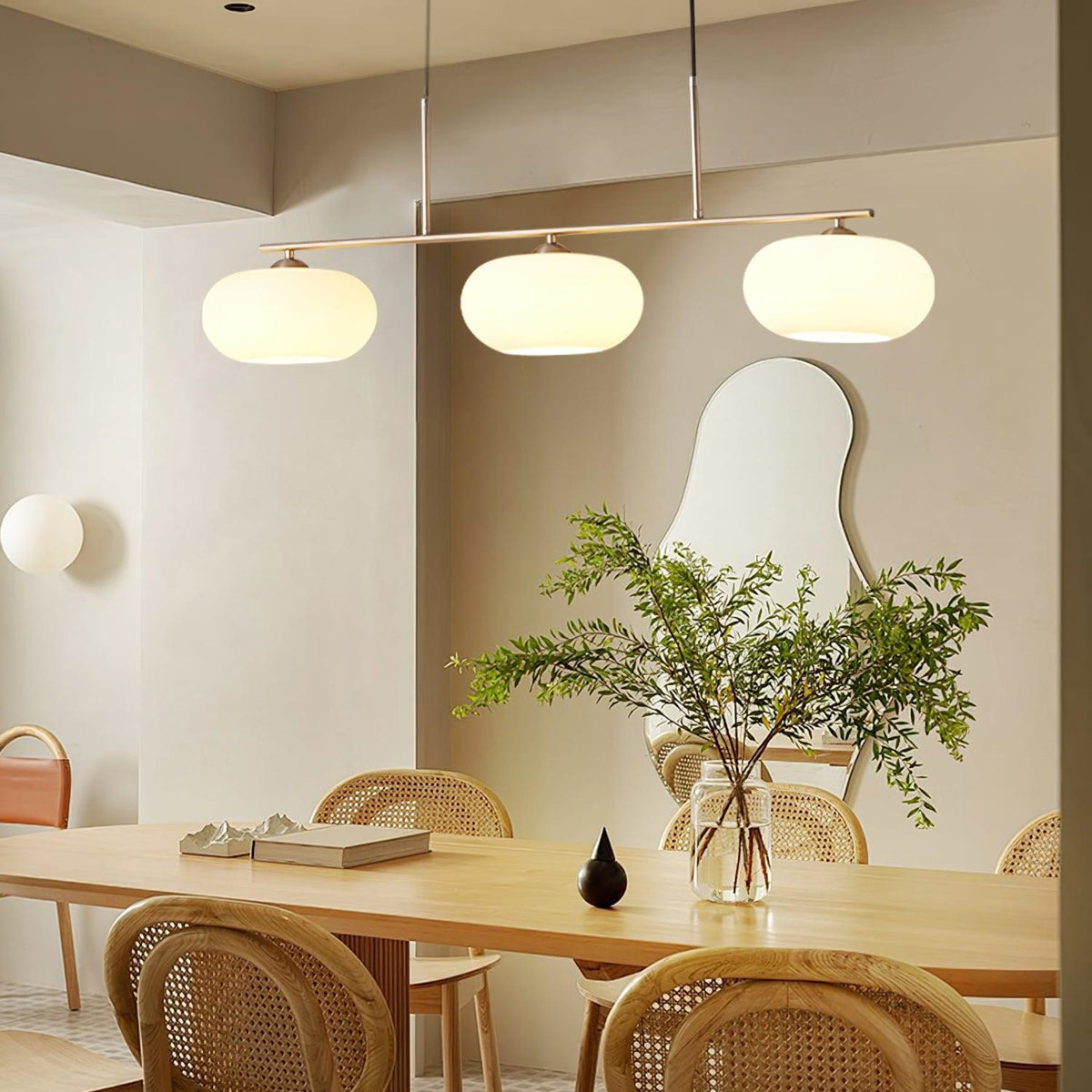 Three-light linear glass pendant in a dining room