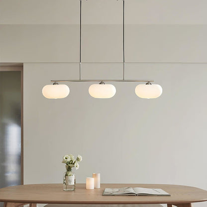 Three-light linear glass pendant in a dining room