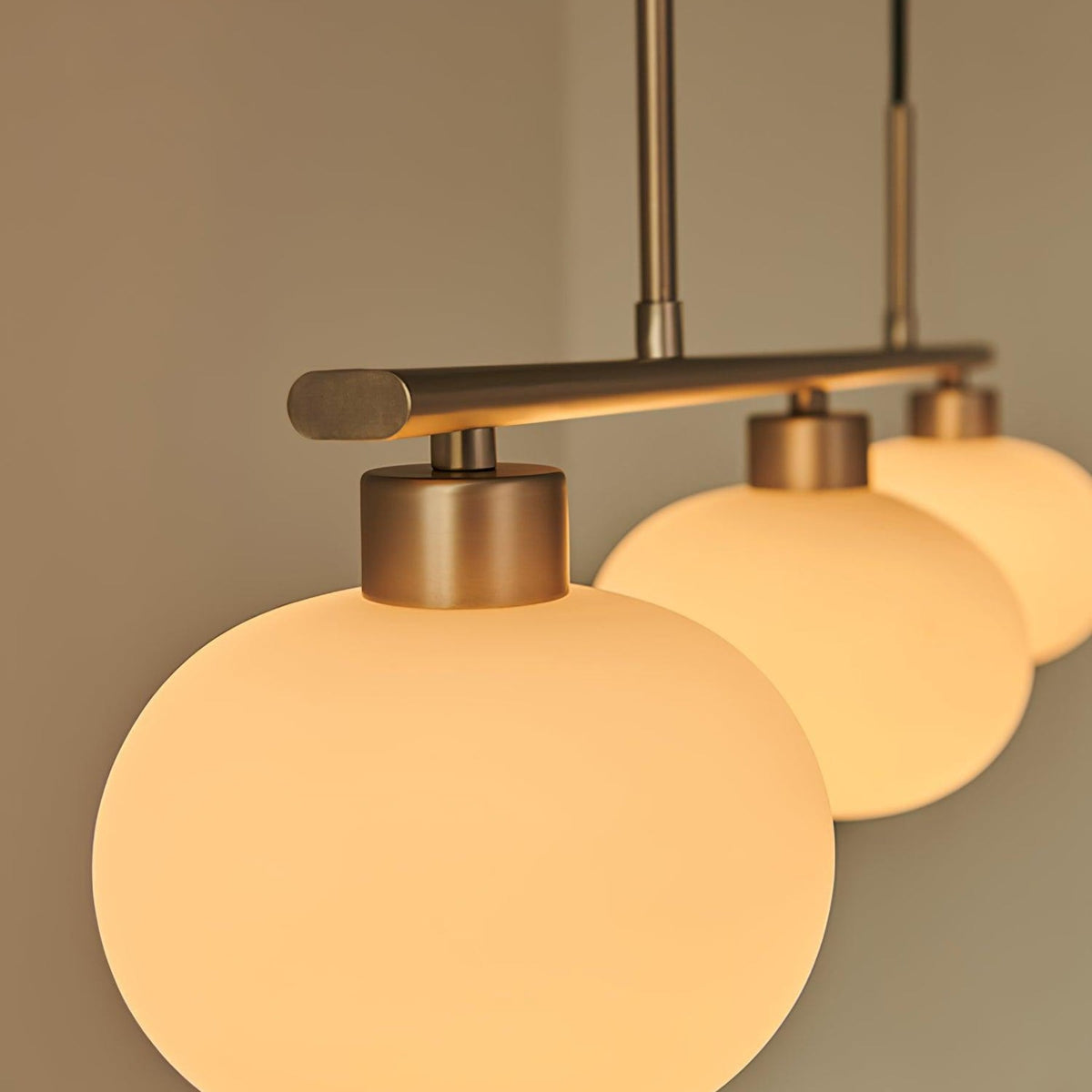 Close view of glass pendant shade and metal frame