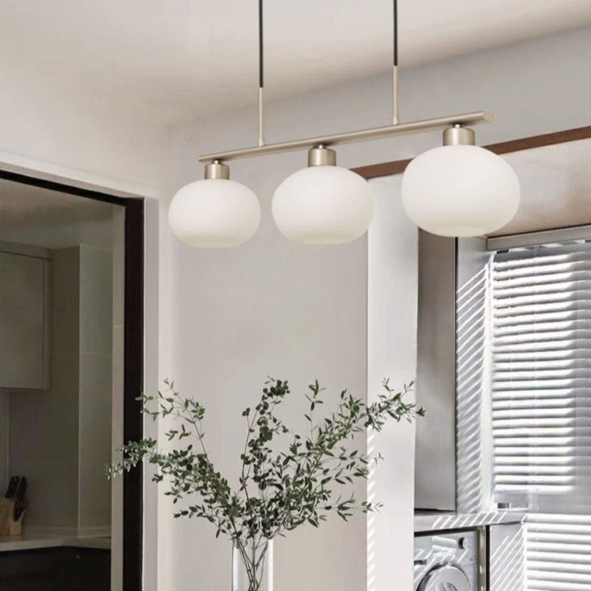 Three-light linear glass pendant in a dining room