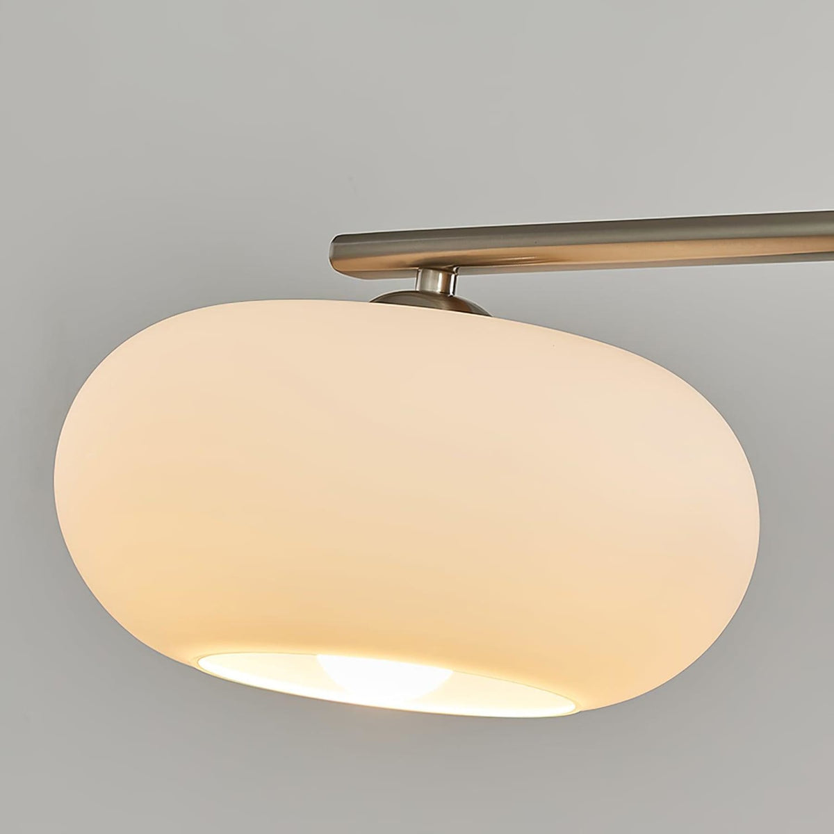 Close view of glass pendant shade and metal frame