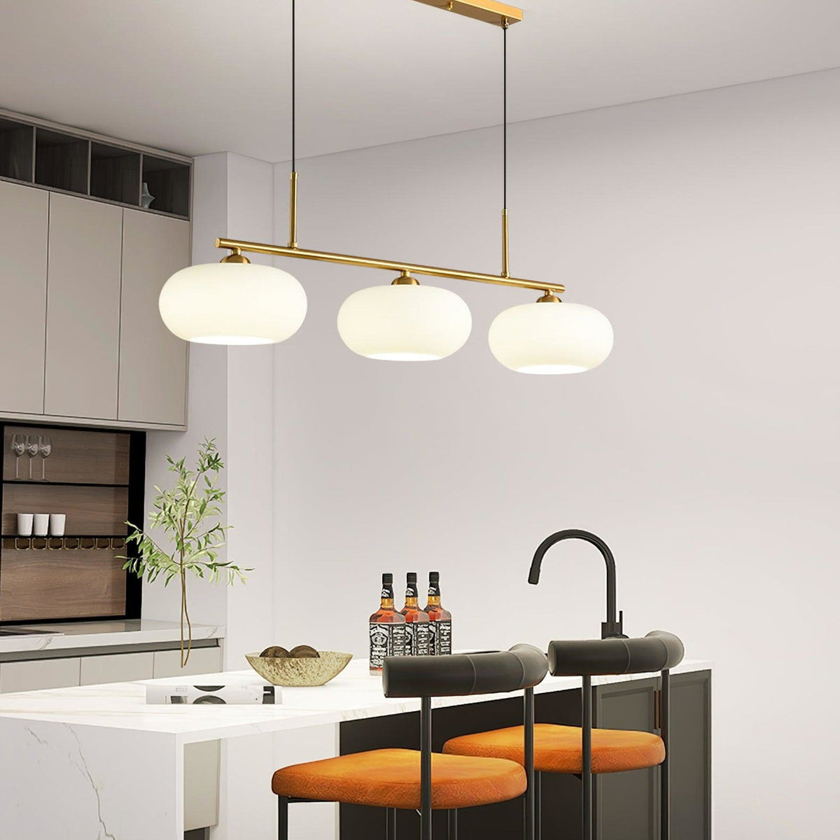 Three-light glass pendant above a kitchen island