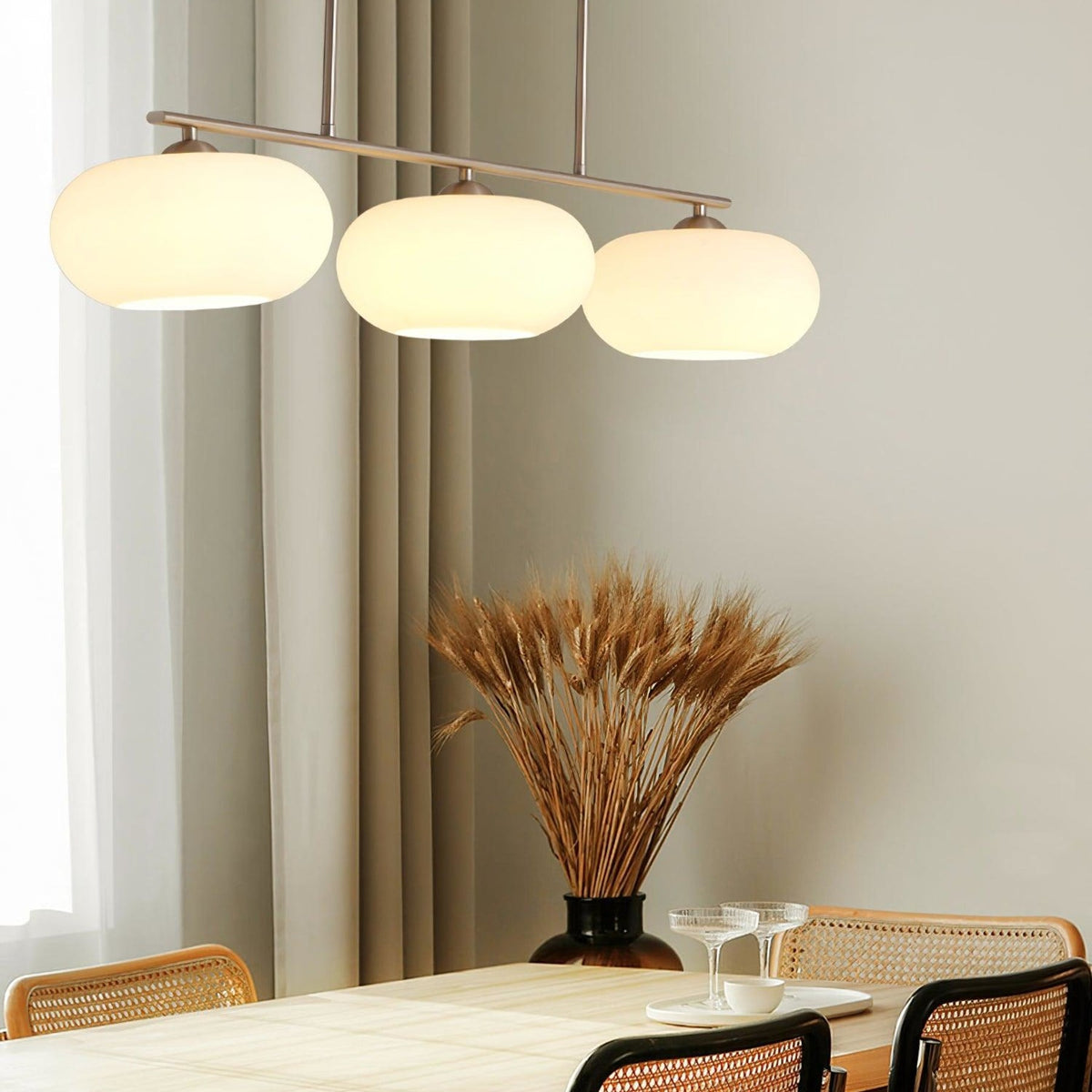 Three-light linear glass pendant in a dining room