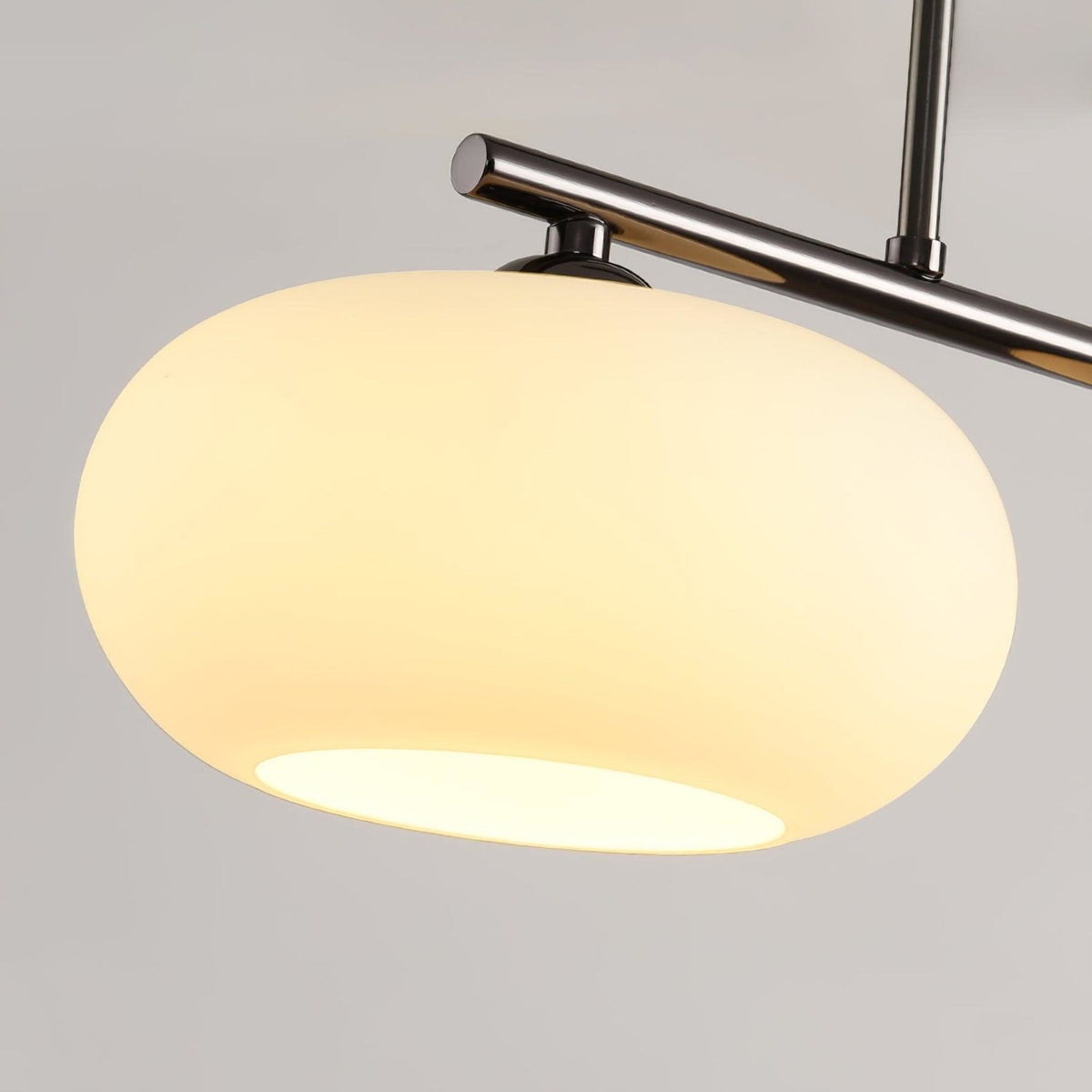 Close view of glass pendant shade and metal frame