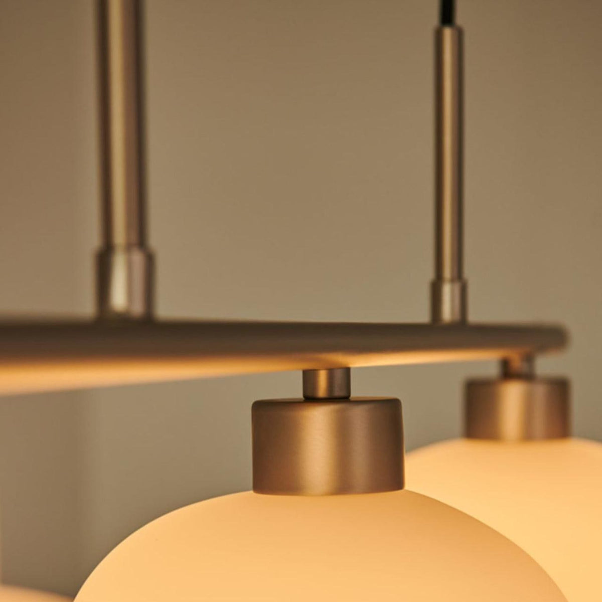 Close view of glass pendant shade and metal frame