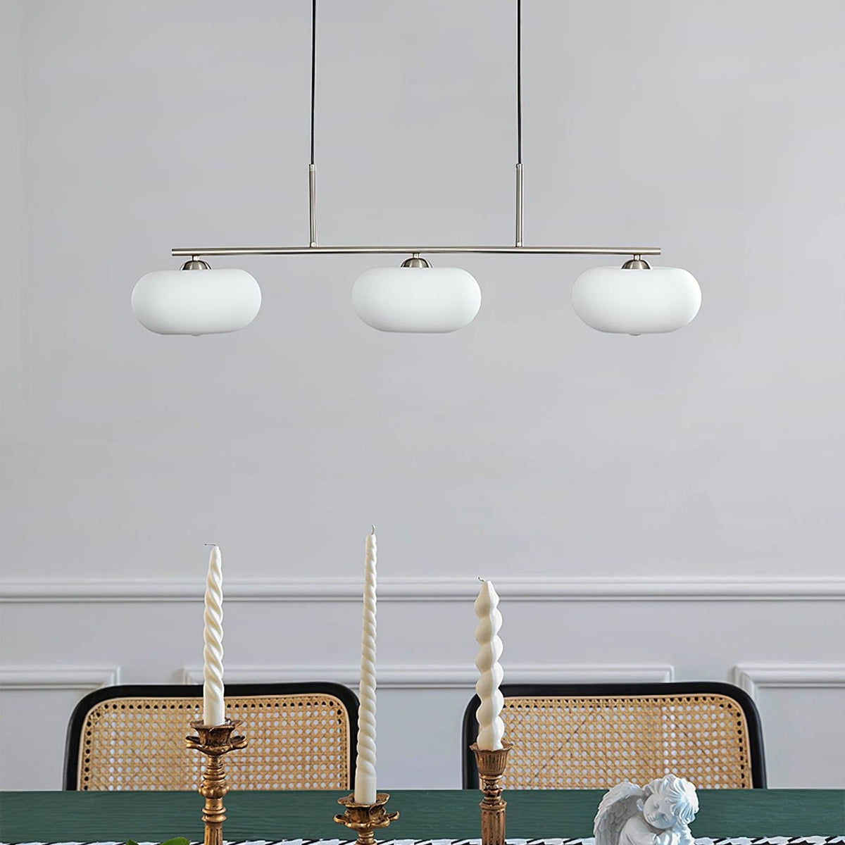 Three-light linear glass pendant in a dining room