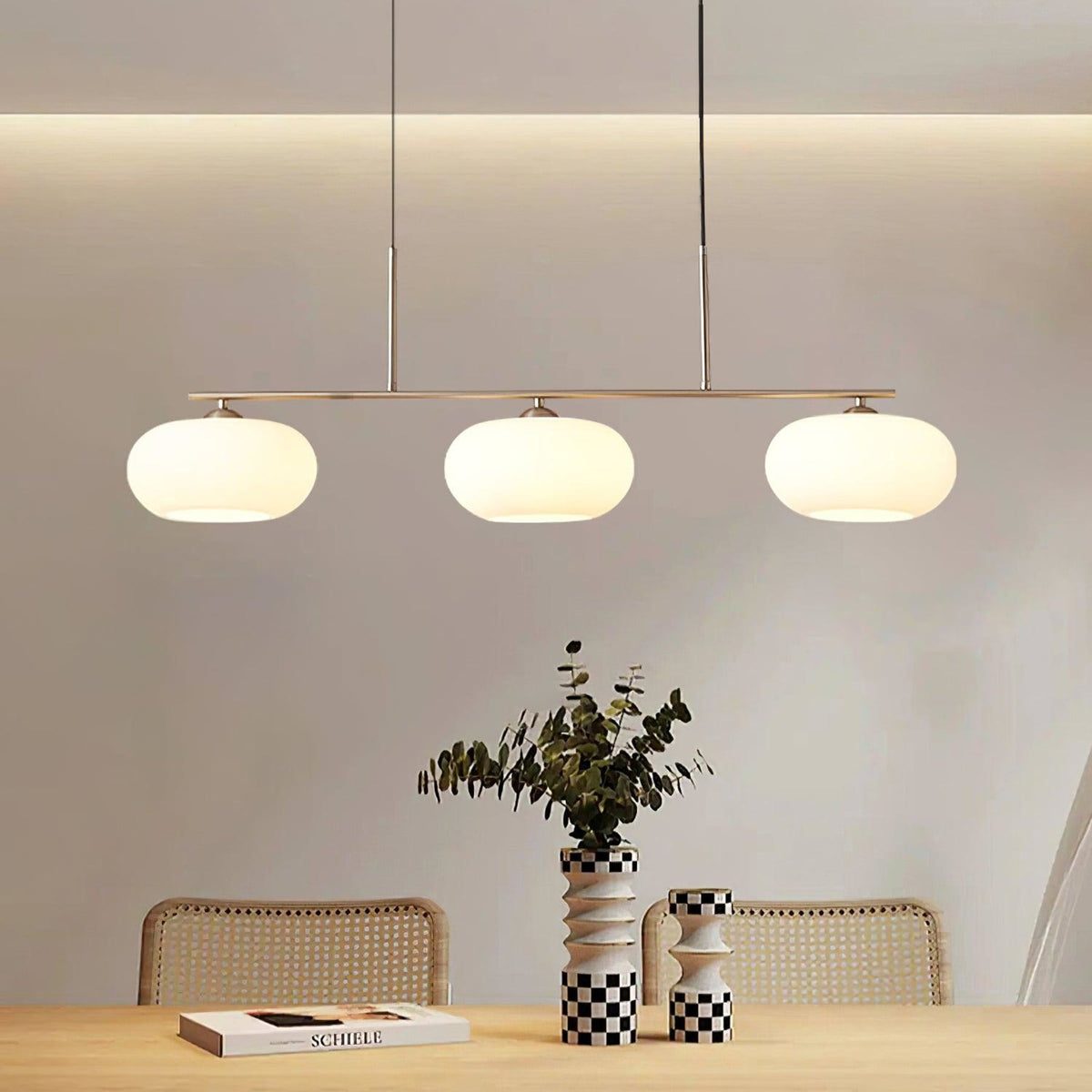 Three-light linear glass pendant in a dining room