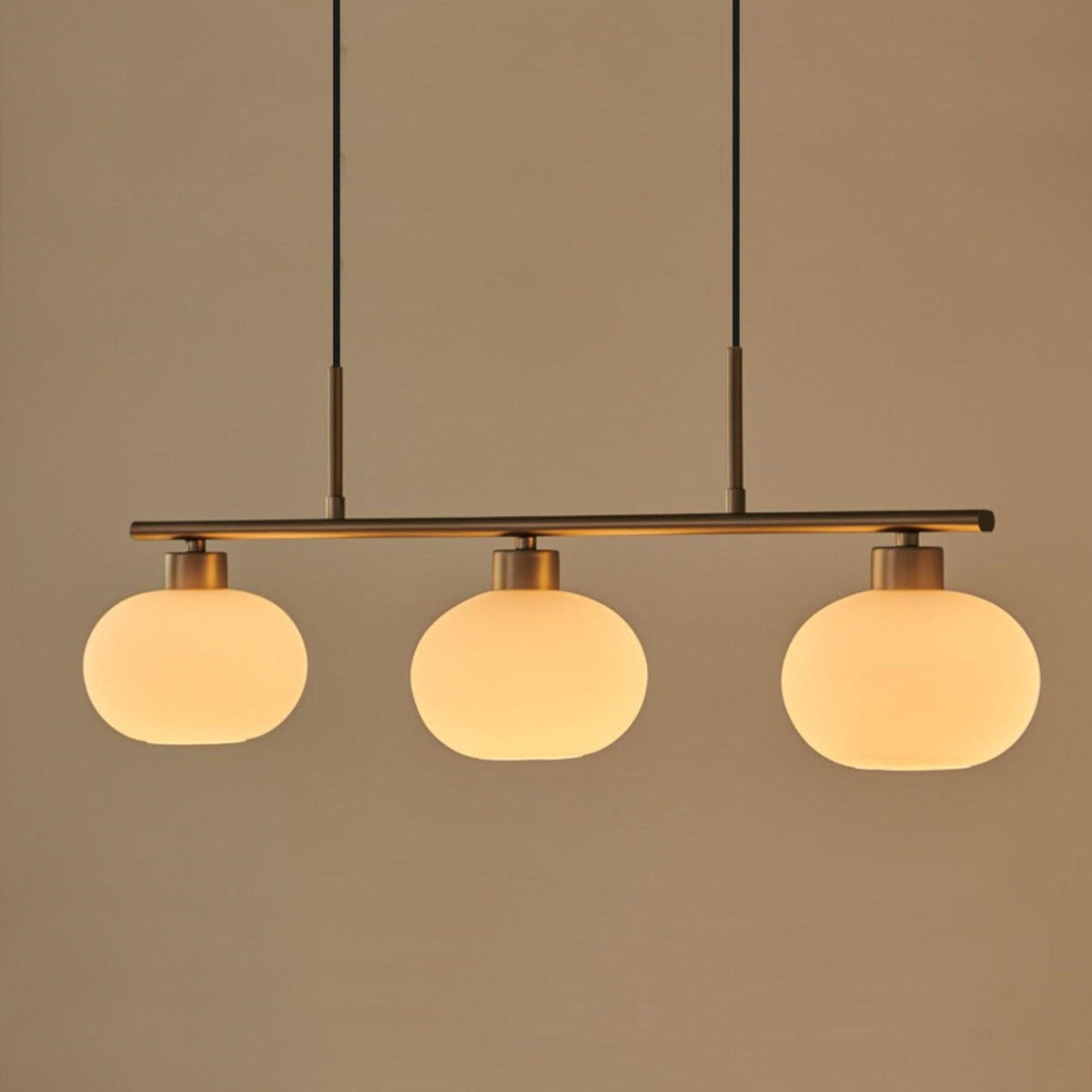 Three-light linear pendant with white glass shades