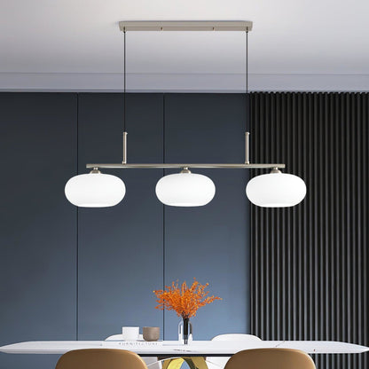 Three-light linear glass pendant in a dining room