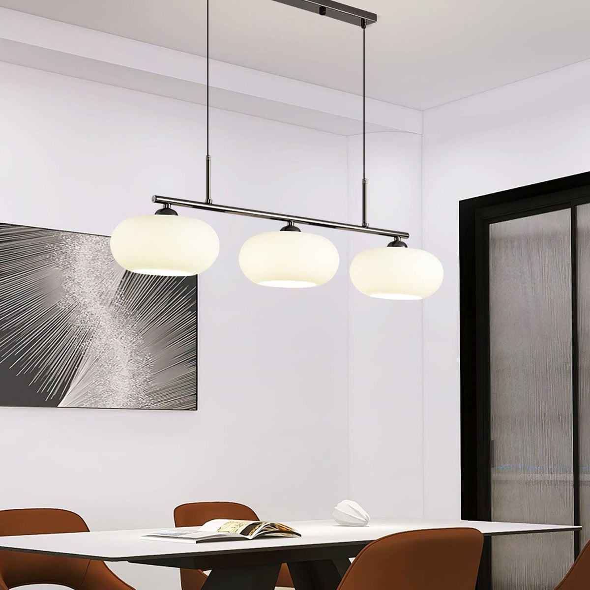 Three-light linear glass pendant in a dining room