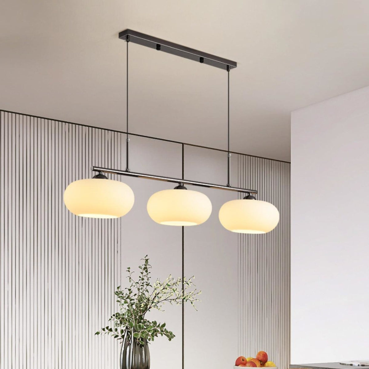 Three-light linear glass pendant in a dining room
