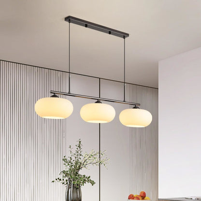 Three-light linear glass pendant in a dining room