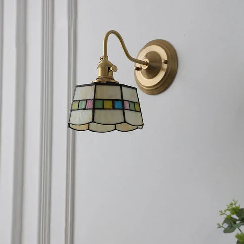 Decorative glass wall sconce mounted on a wall