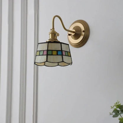 Decorative glass wall sconce mounted on a wall
